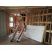 A construction worker preparing to install ducting work 