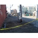 A utility box on a pole behind some caution tape